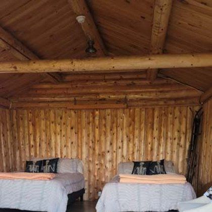 A cabin with two beds and a ceiling fan