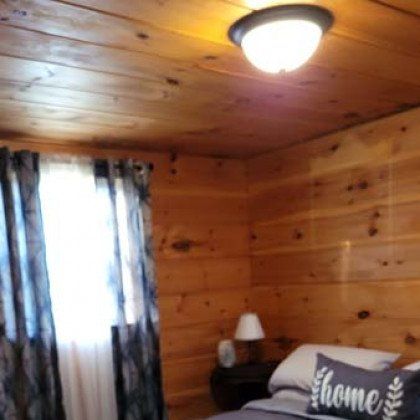 A bedroom with a bed and a pillow that says `` home ''.