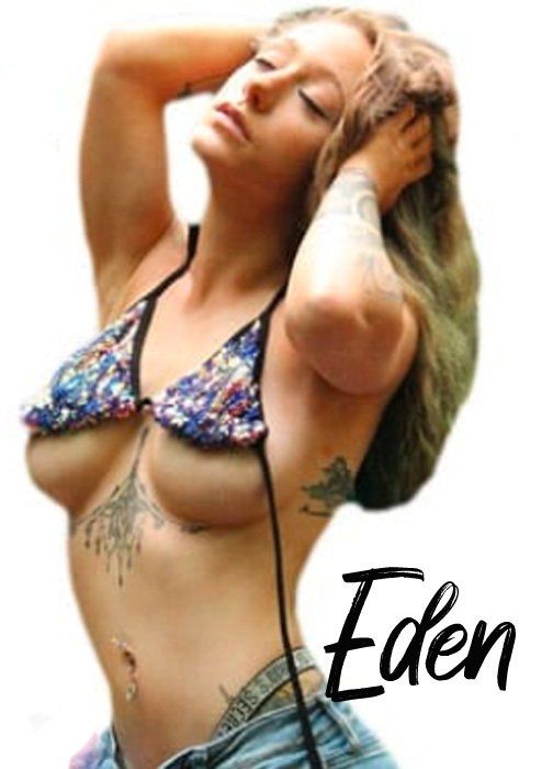 Woman in bikini, arms up, eyes closed, tattoos, with