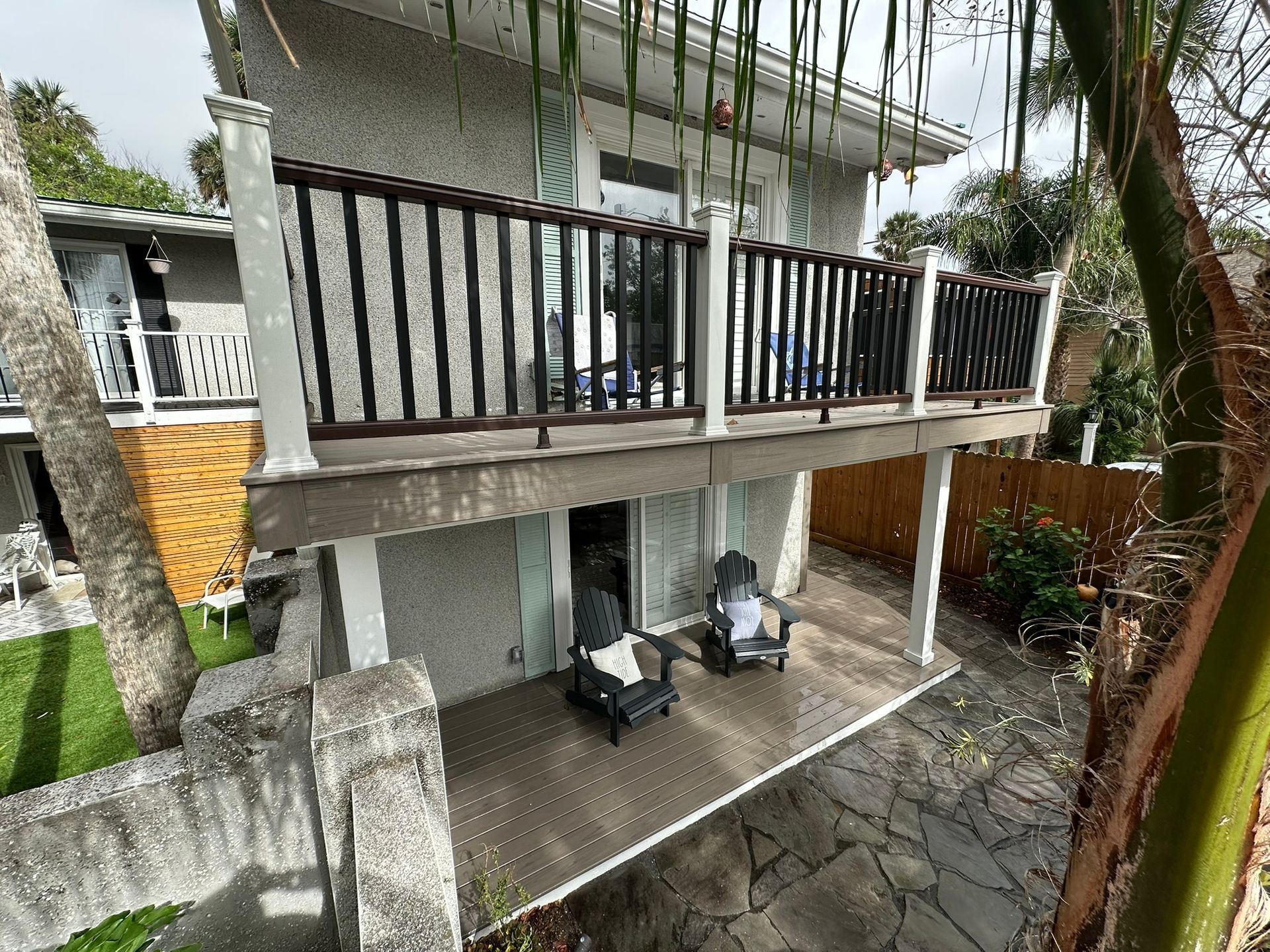 A house with a balcony and chairs on it