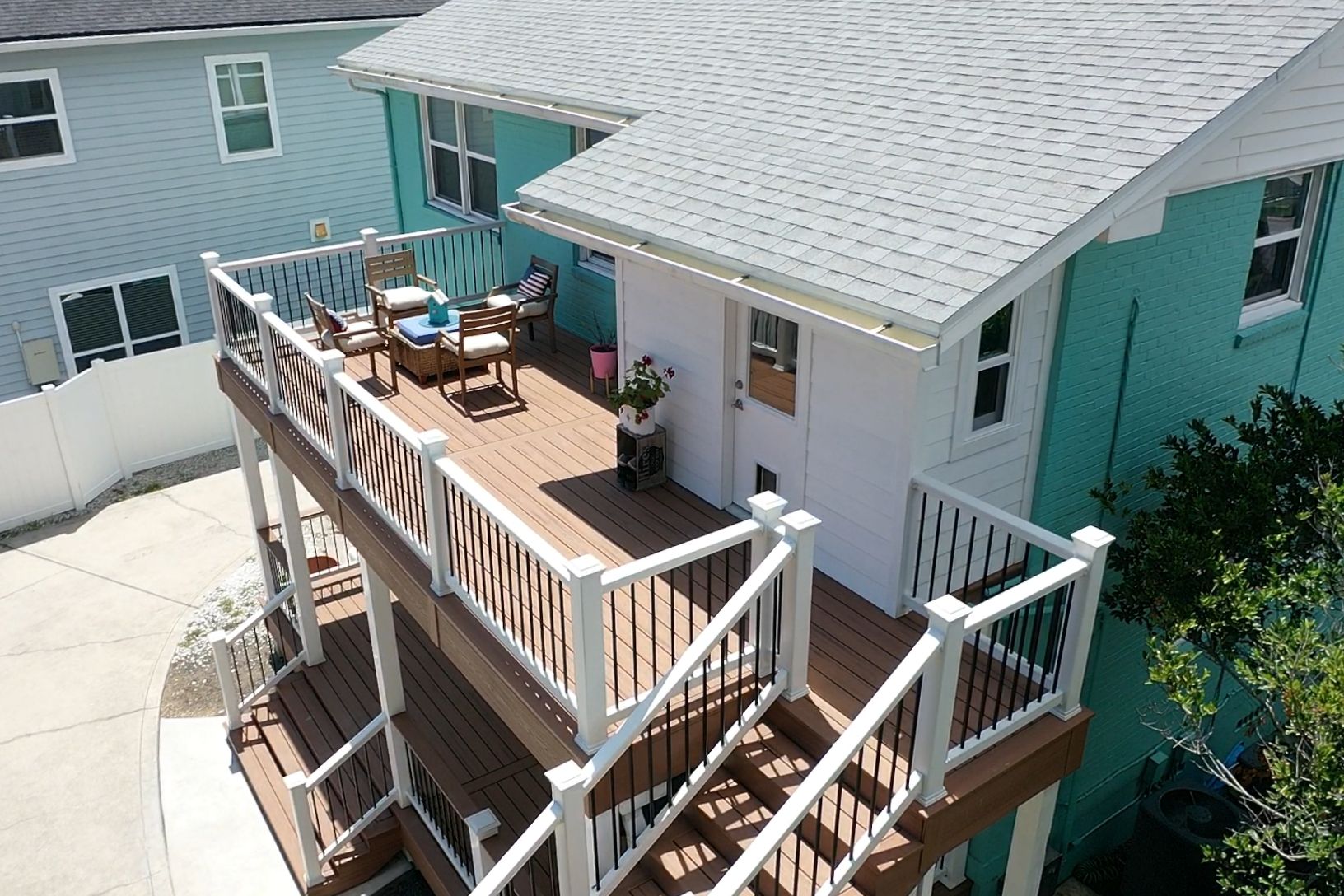 An aerial view of a house with a large deck.