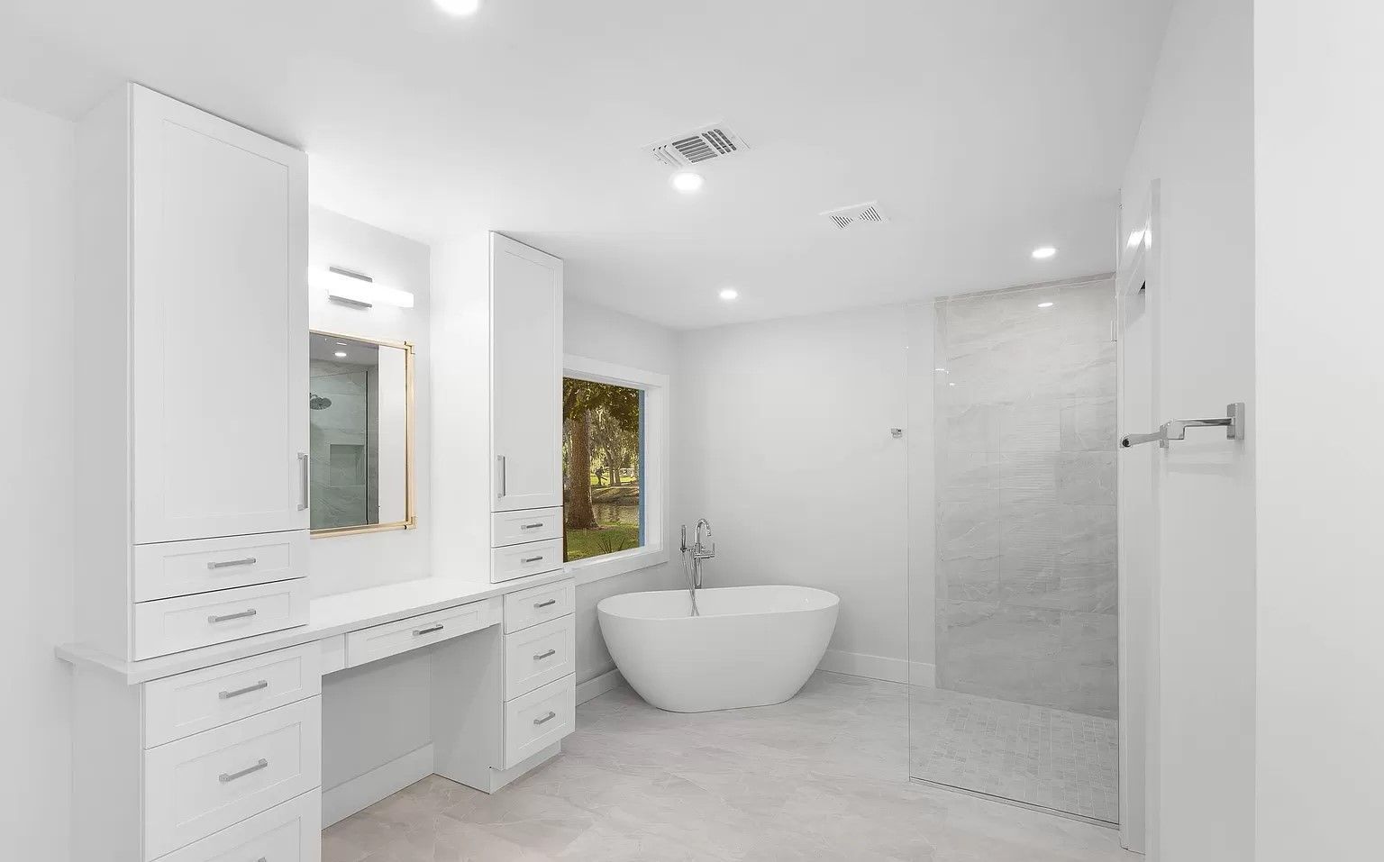 A bathroom with a bathtub and a walk in shower.