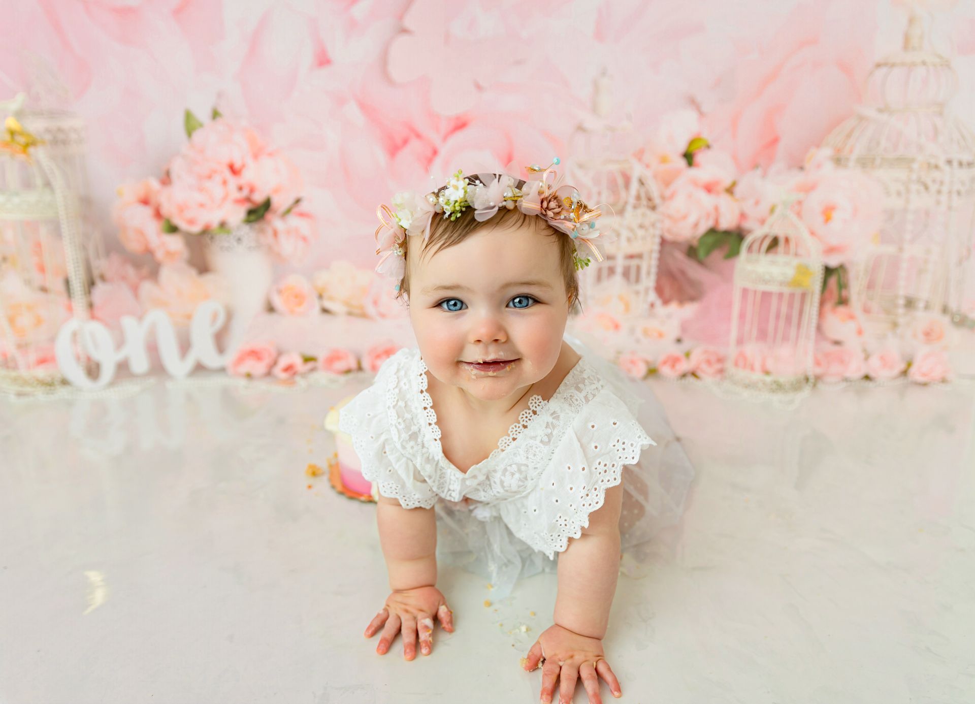First birthday cake smash with soft florals in Cary, NC photography studio