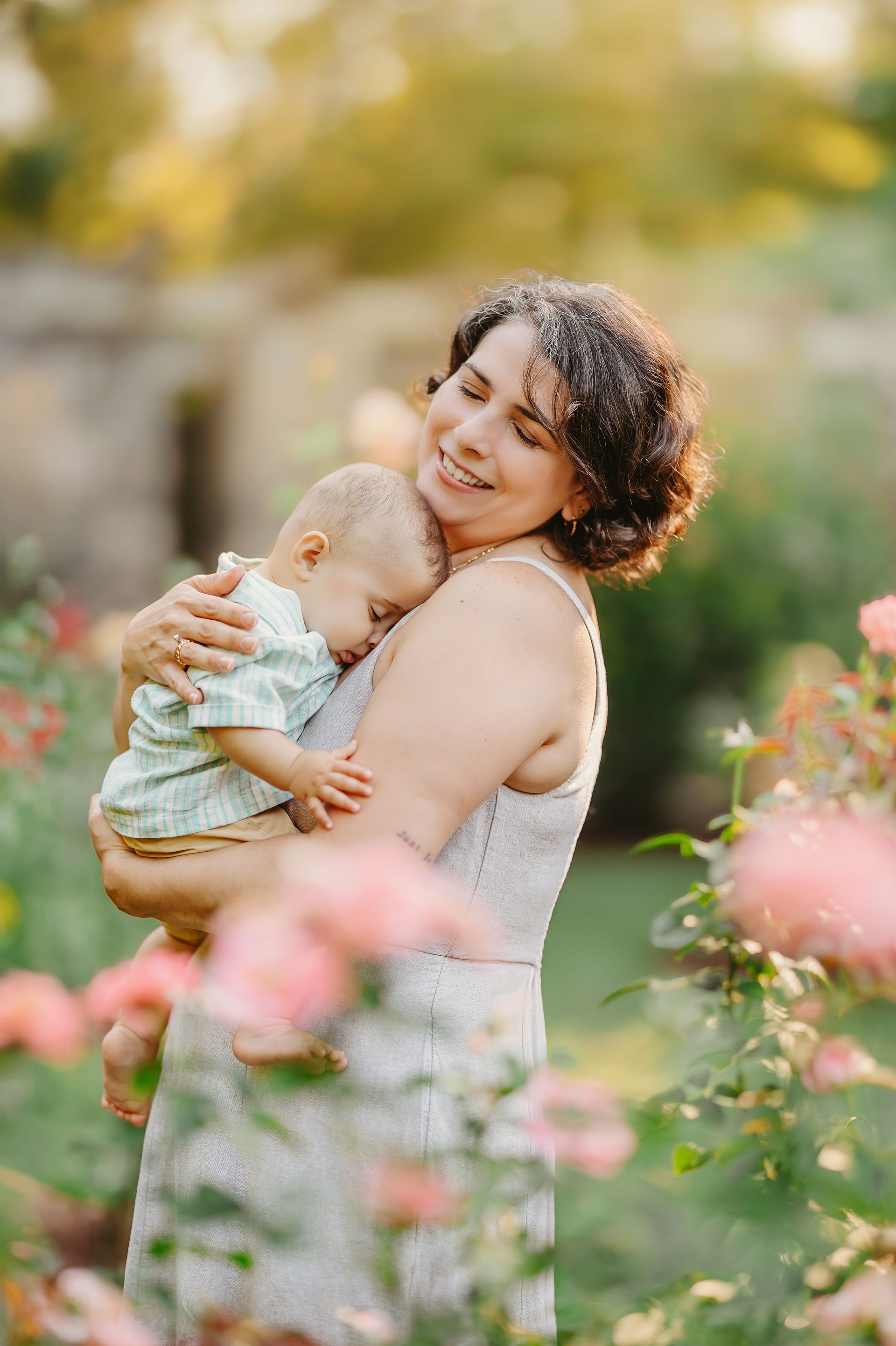 Mother, Father and baby boy portrait during a summer morning session at the Raleigh Rose Garden, NC