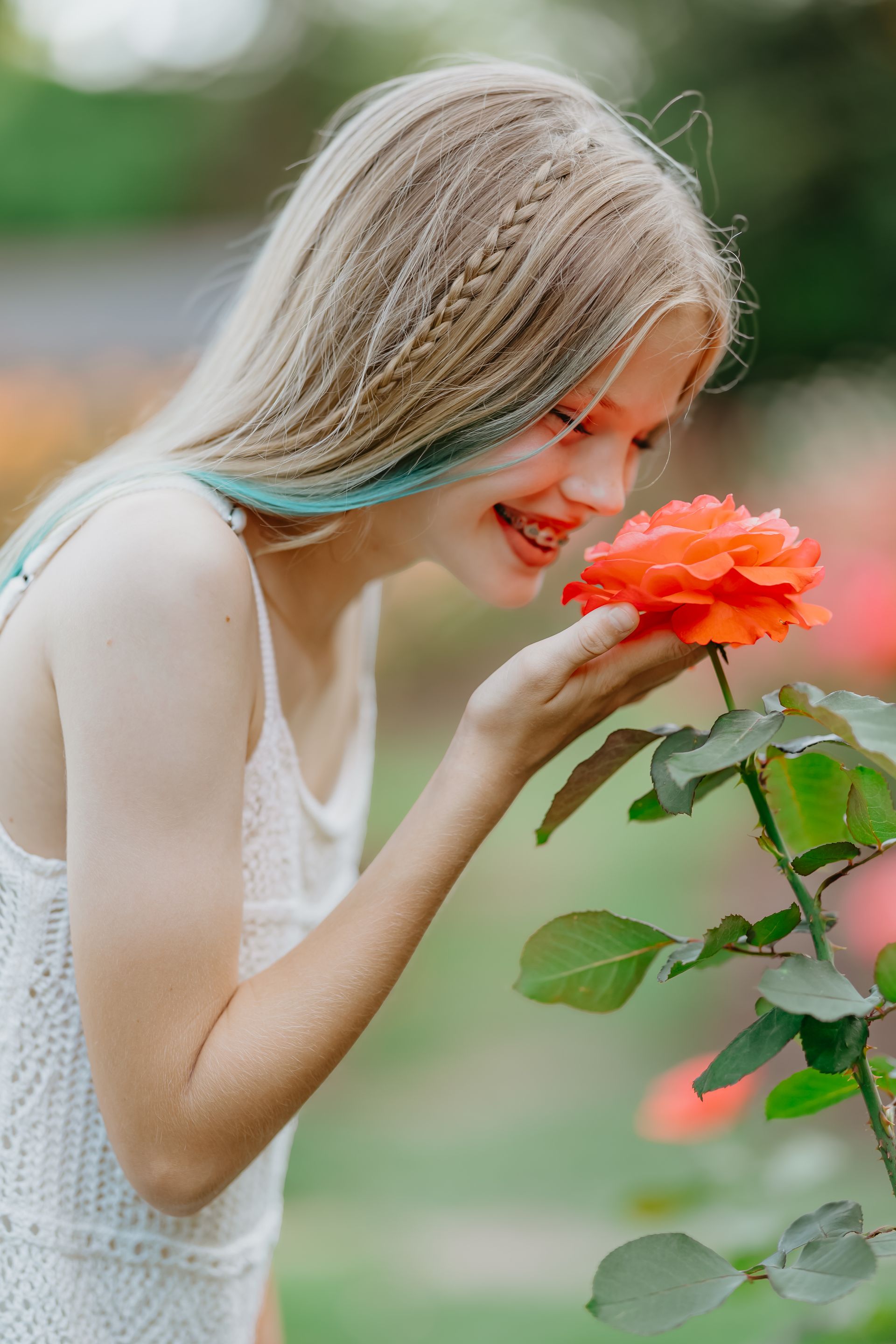 Beautiful girl smelling a rose at the Raleigh Rose Garden

