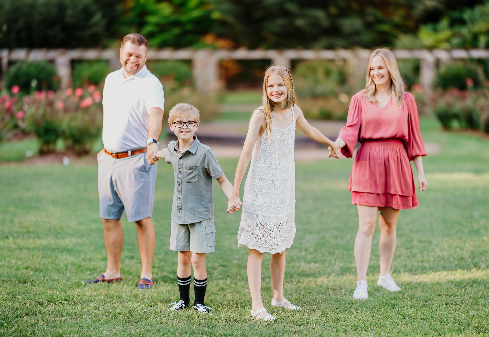 Family holding hands at the Raleigh Rose Garden 