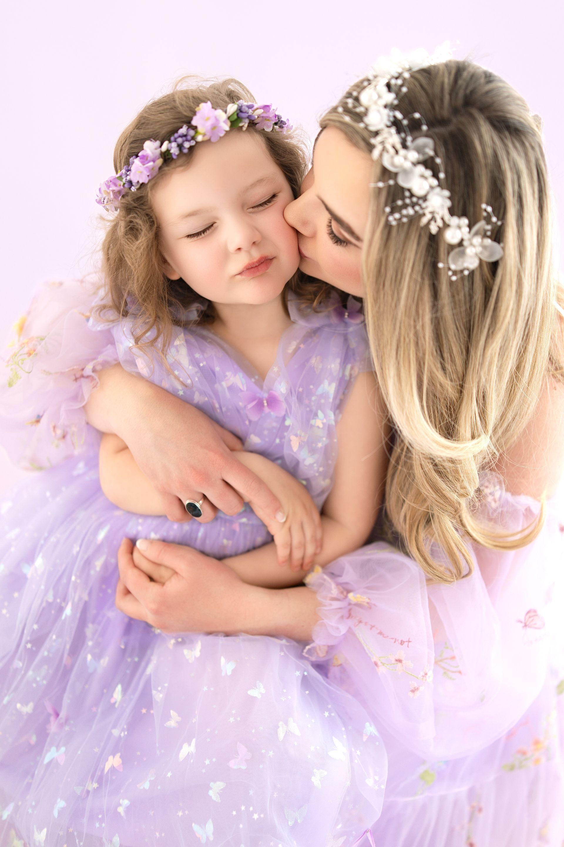 un candid moment of mom and daughter laughing during milestone photoshoot