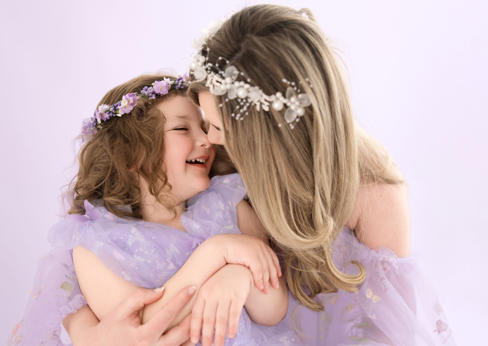mother and daughter smiling at each other during the  milestone studio session