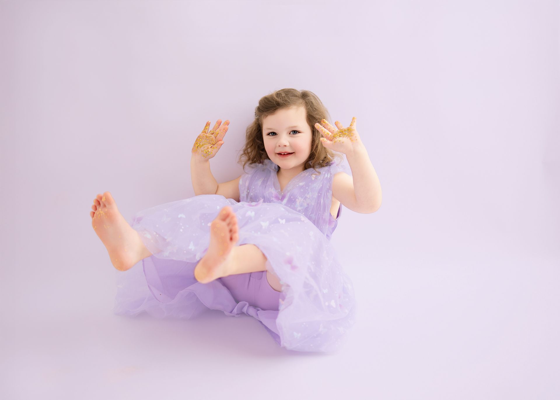 4 years old girl having fun with glitter studio session