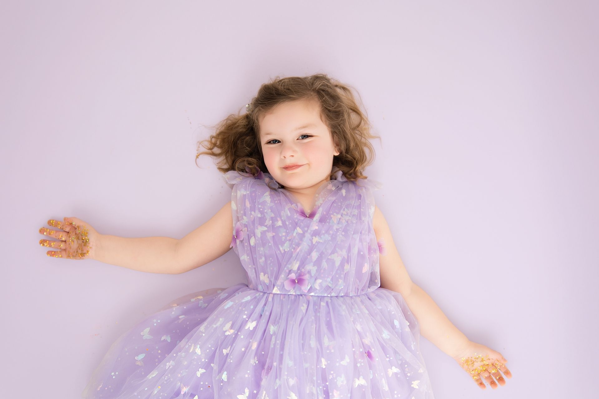Big sister-to-be celebrating her fourth birthday in a purple studio session