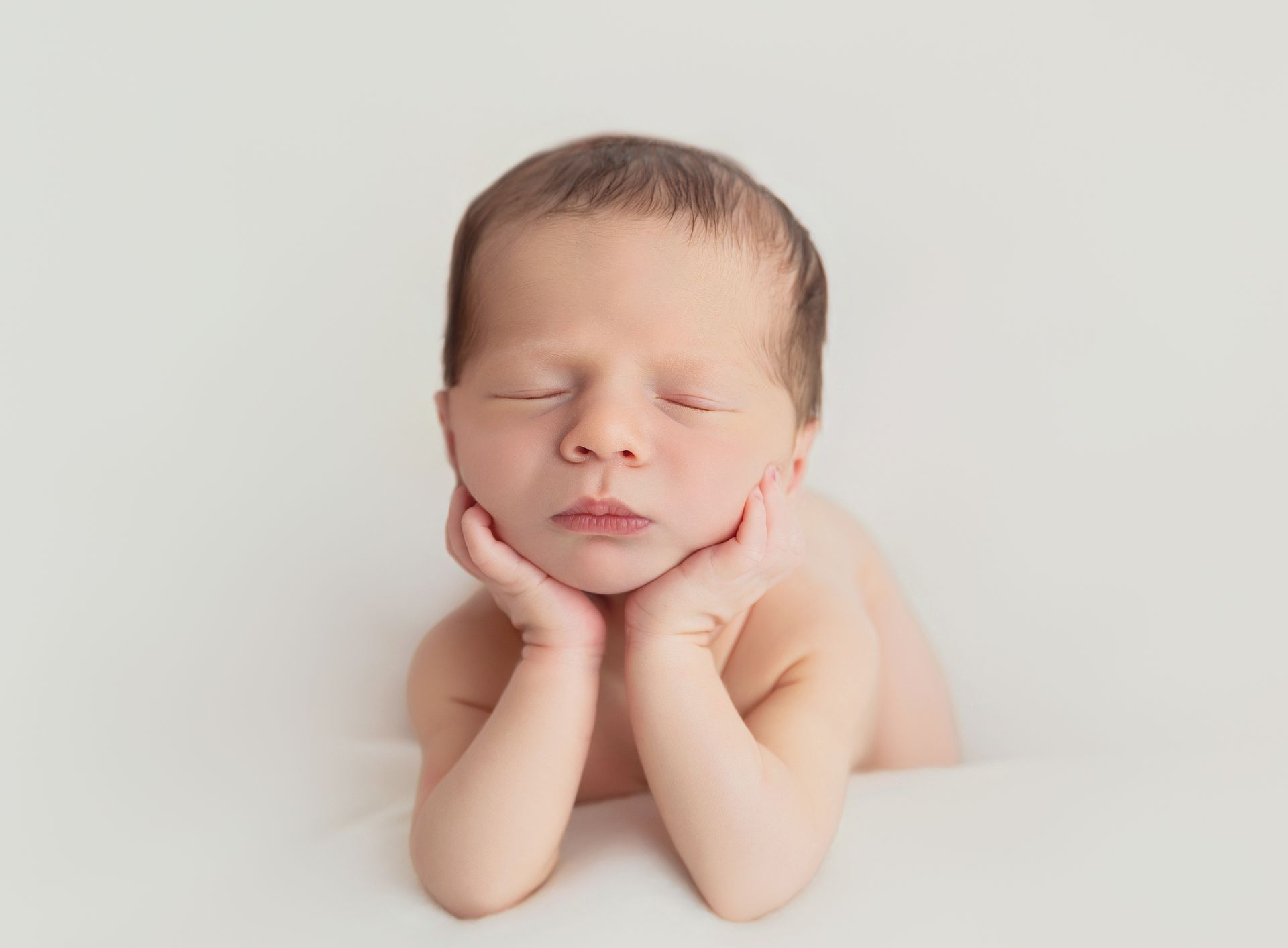 Timeless newborn on frog pose 
portrait with soft natural light in Cary, NC studio