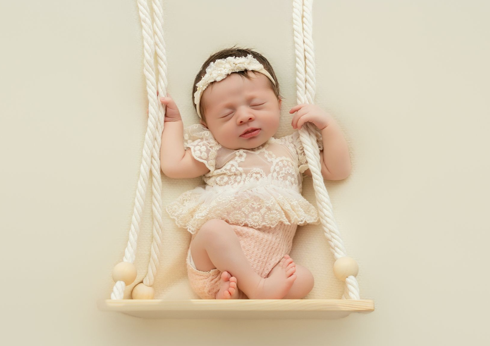 newborn studio photography baby girl in a swing