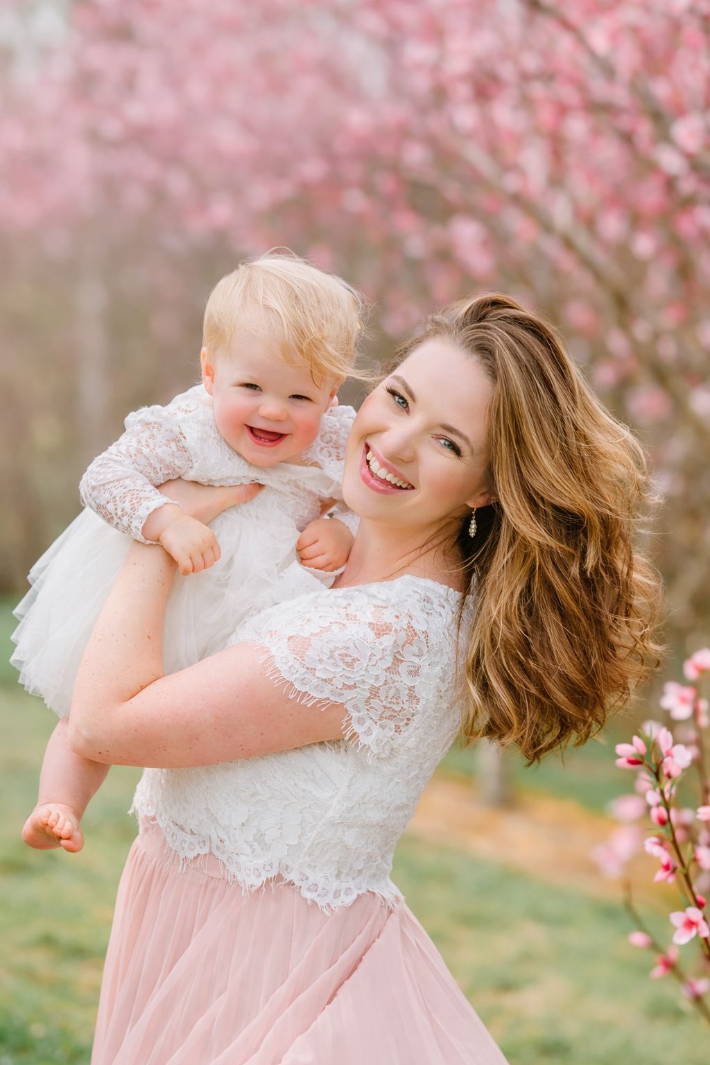 Spring portrait session in peach blossoms on a sunny, bright day near Raleigh, NC
