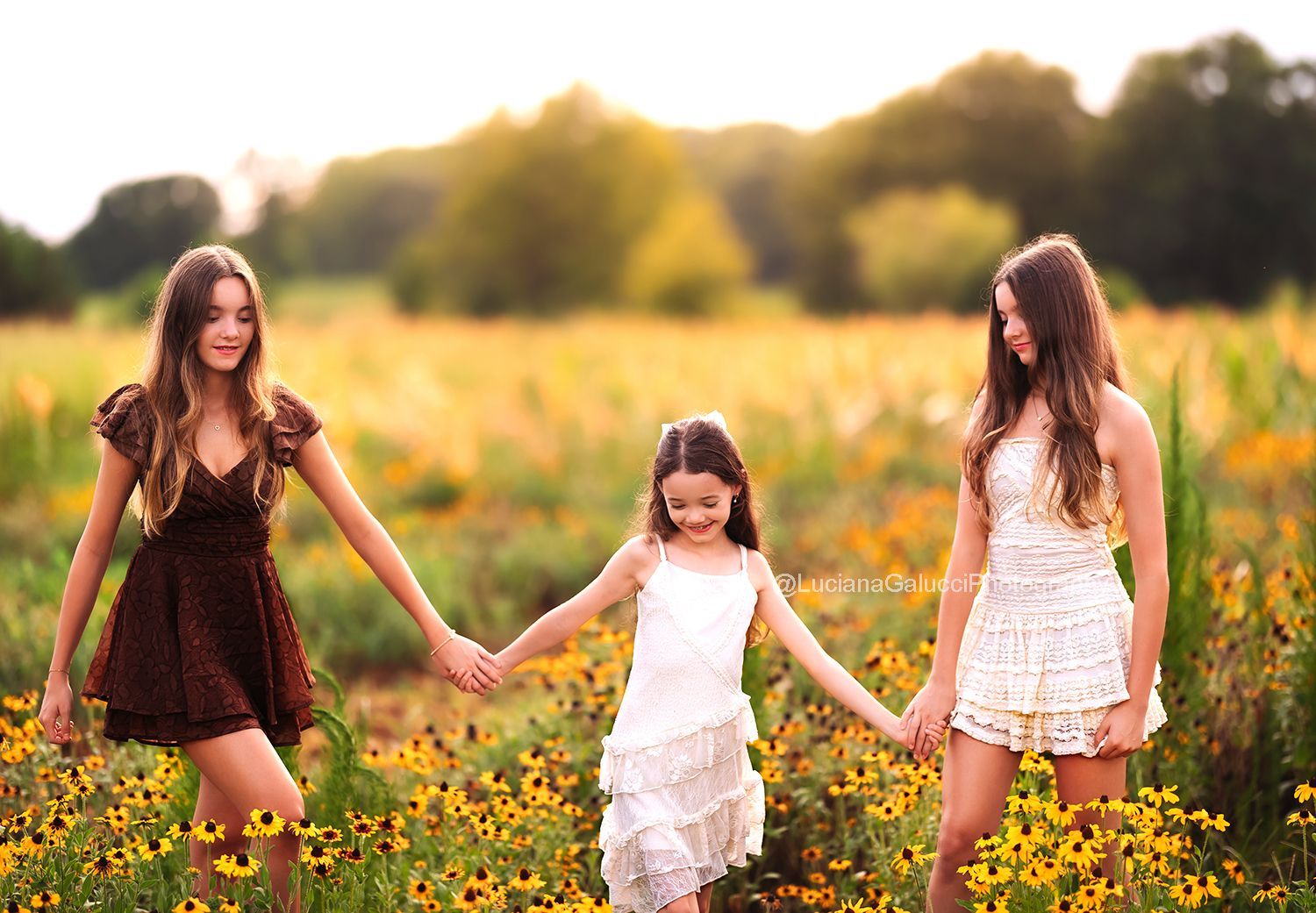 Siblings candid  portrait surrounded by wildflowers at sunset in Raleigh, North Carolina.