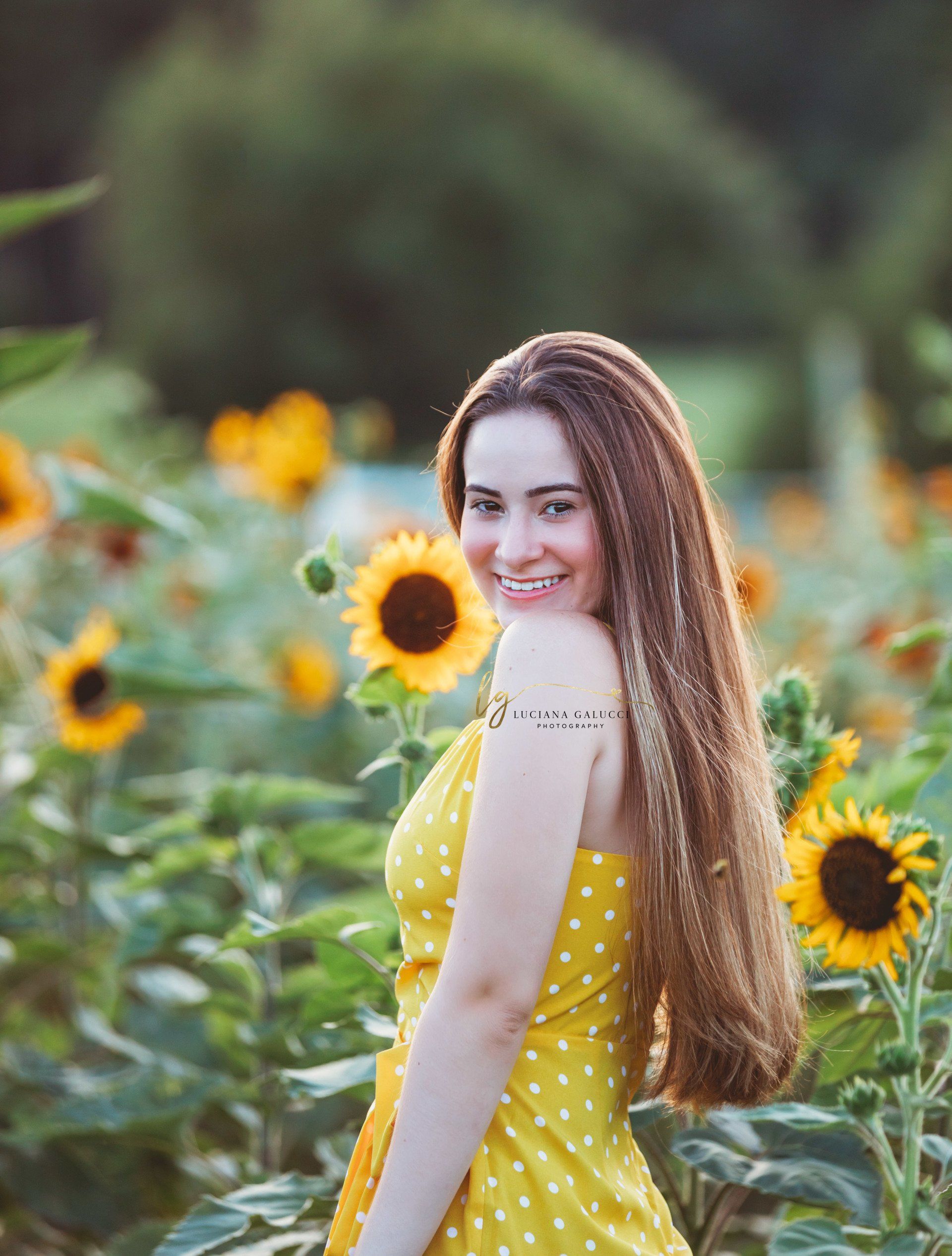 Golden hour senior portrait session in a sunflower field at Dix Park in Raleigh, North Carolina
