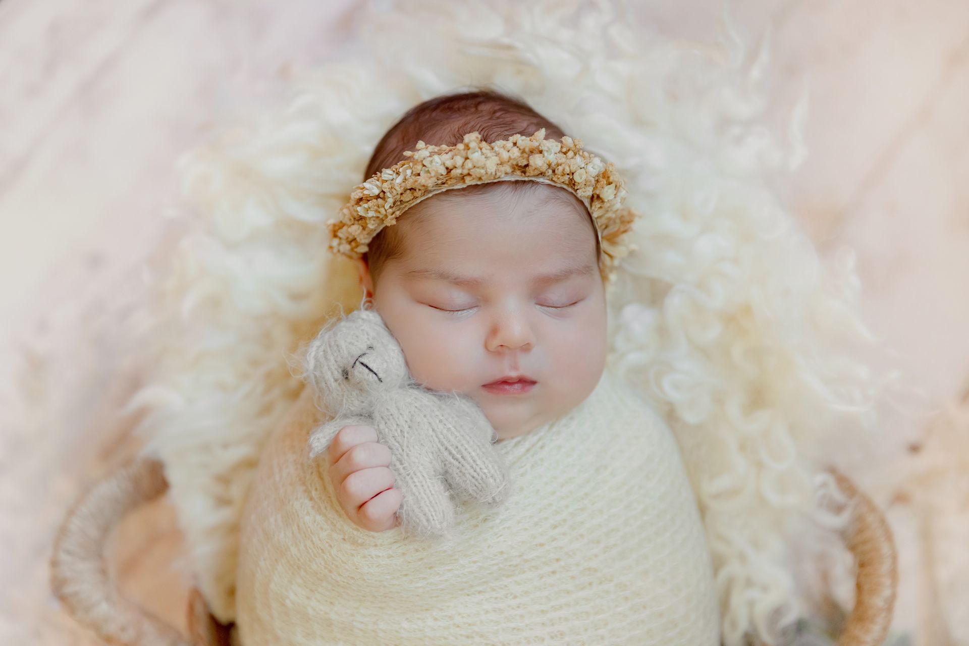 Close-up of sleeping newborn’s face with soft studio lighting
