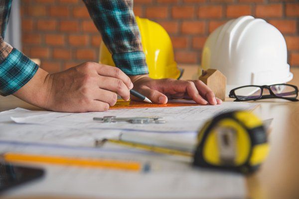 Worker Planning a Barndominium Design — Lubbock, TX — J-Steel Construction, LLC