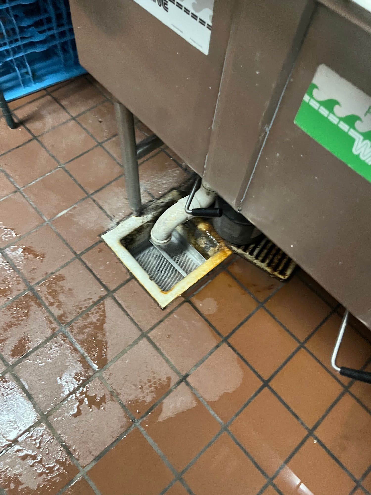 A sink with a green sticker on it that says ' stainless steel '