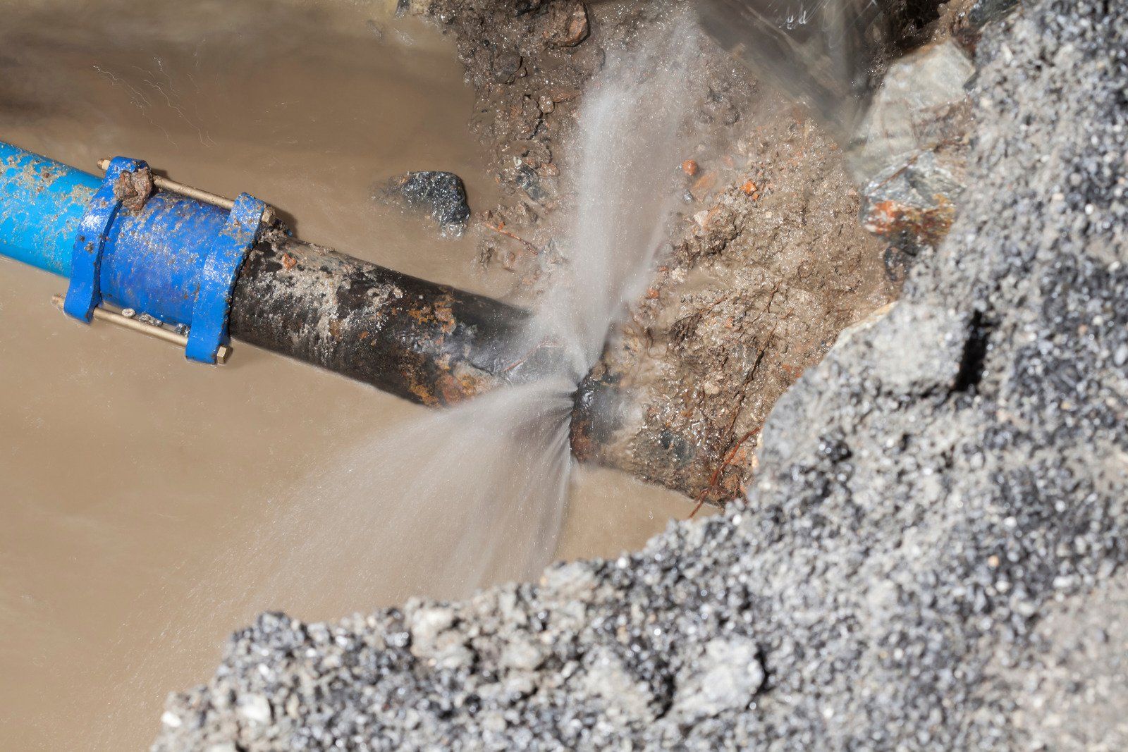 A water pipe is leaking water into the ground.