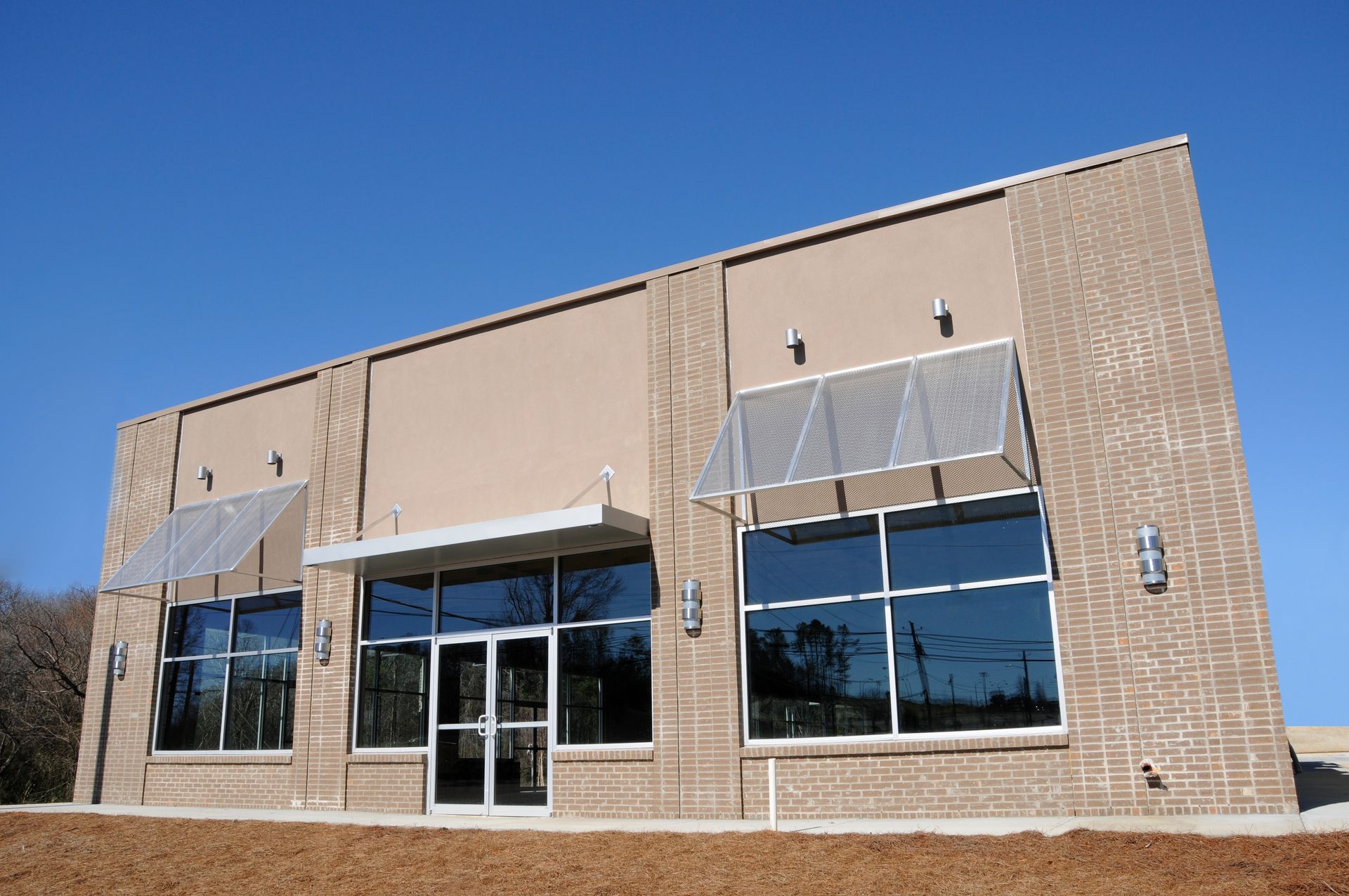 A brick building with a lot of windows and awnings