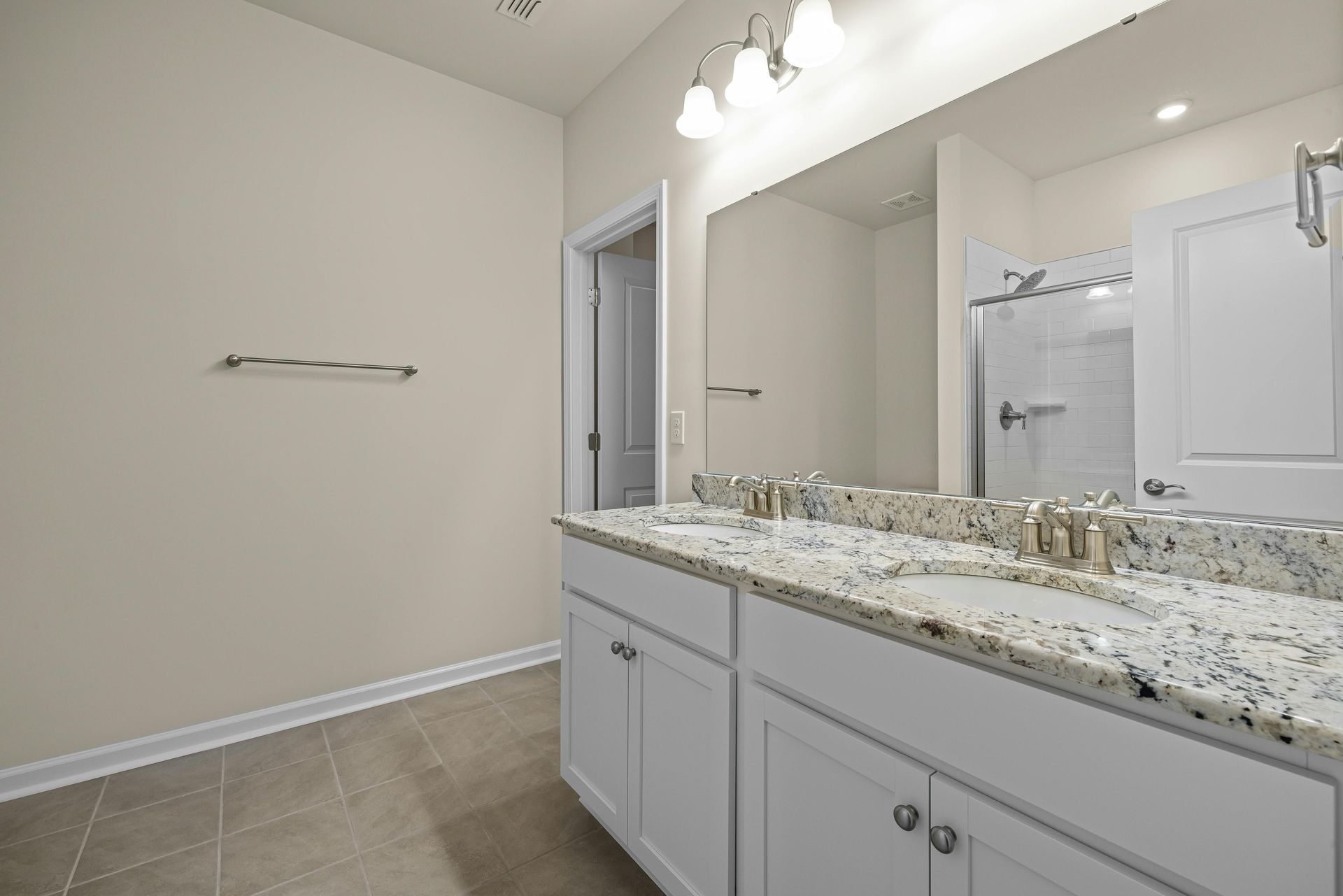 A bathroom with two sinks and a large mirror.