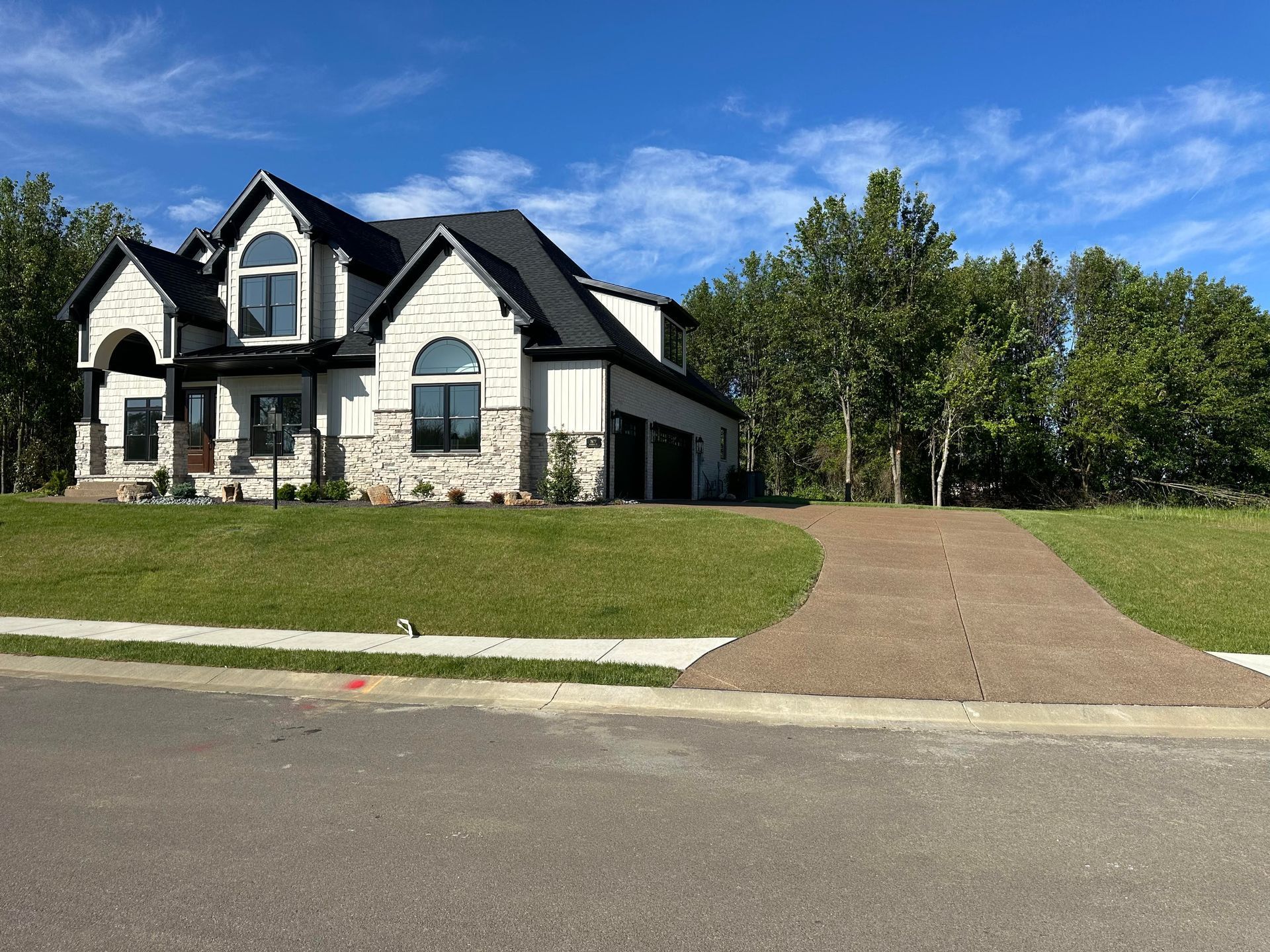 A large house with a driveway leading to it