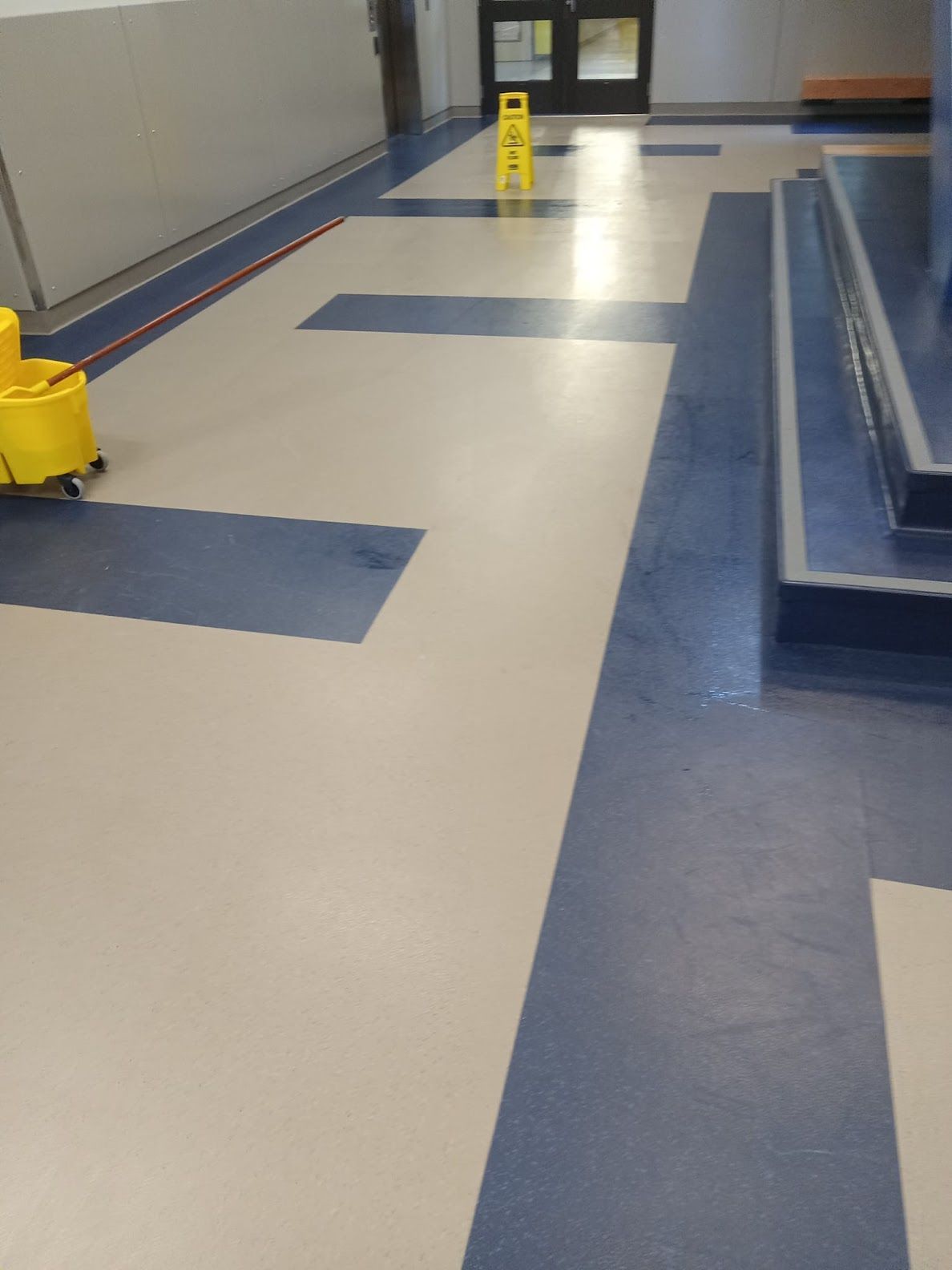 A man in a protective suit is disinfecting a room with a machine.