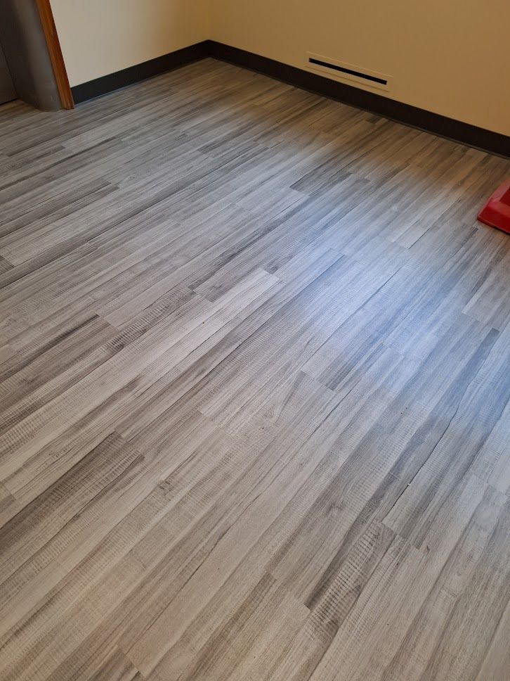 A person is using a vacuum cleaner on a carpeted floor