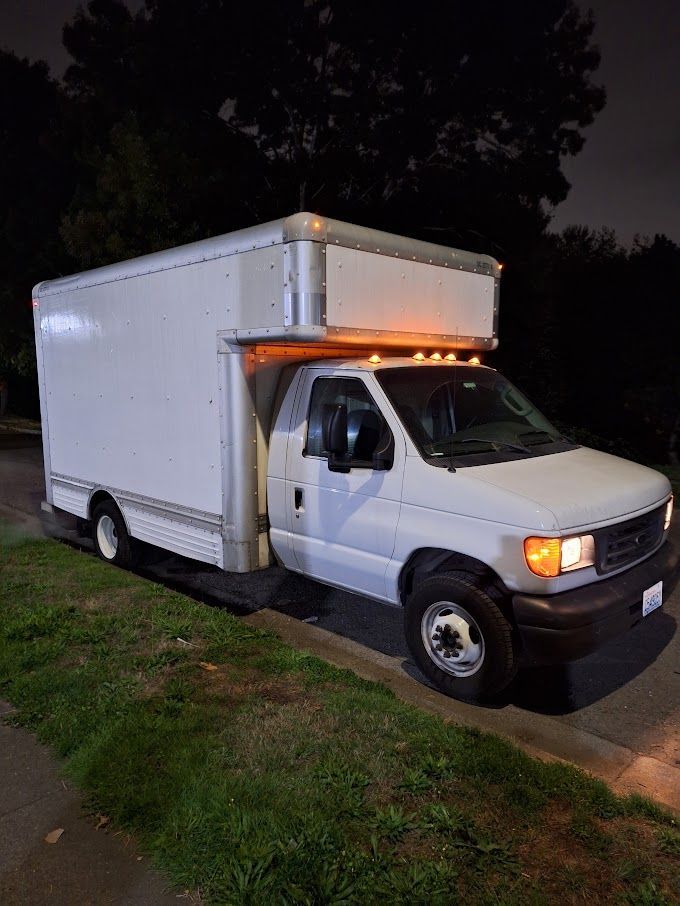 A man in a protective suit is standing in front of a caution tape.