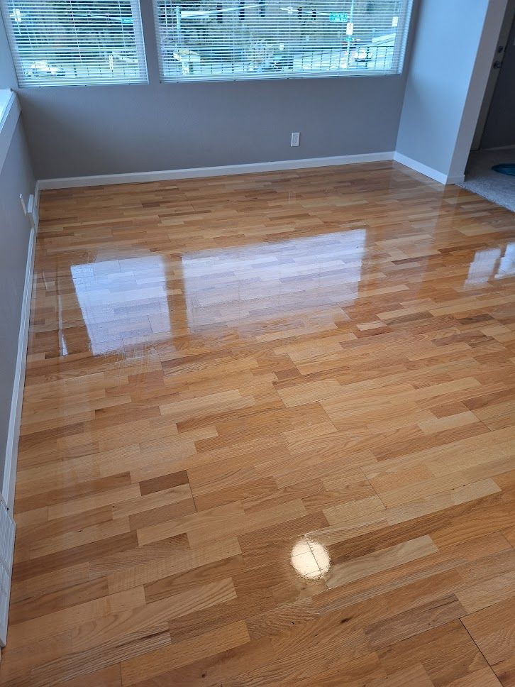 A kitchen with wooden cabinets and a wooden floor