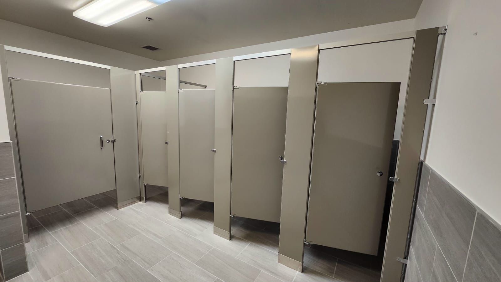 A bathroom with two sinks and a paper towel dispenser