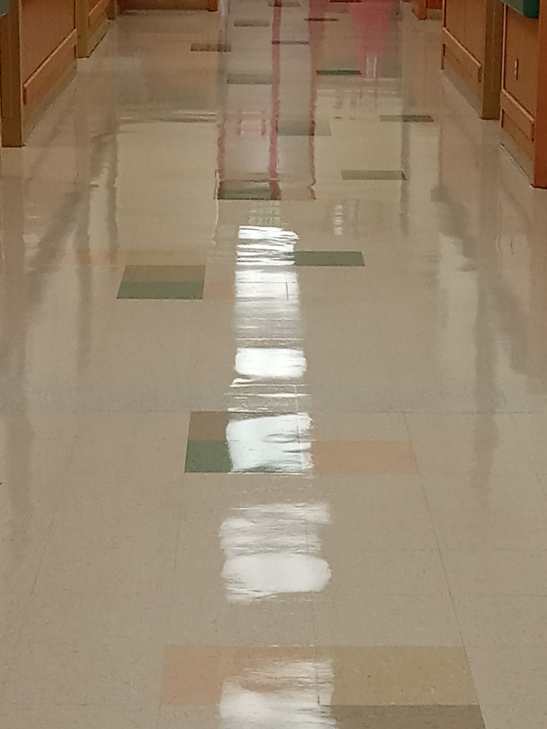 A machine is polishing a concrete floor in a building.