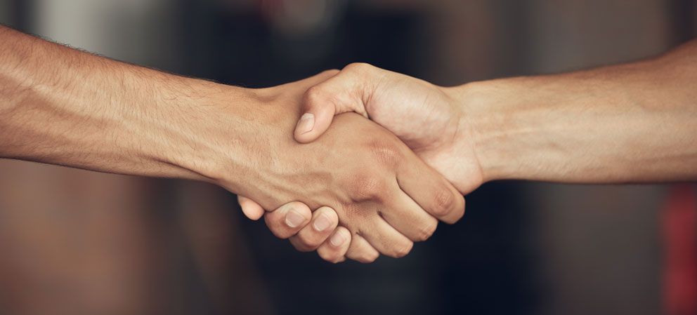 An image of two people shaking hands