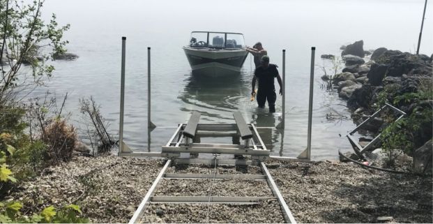 An image of the Docks Unlimited crew assisting with moving a boat out of the water using a marine railway