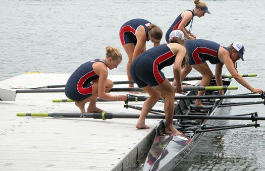 An image of a rowing team in action on a rowing dock