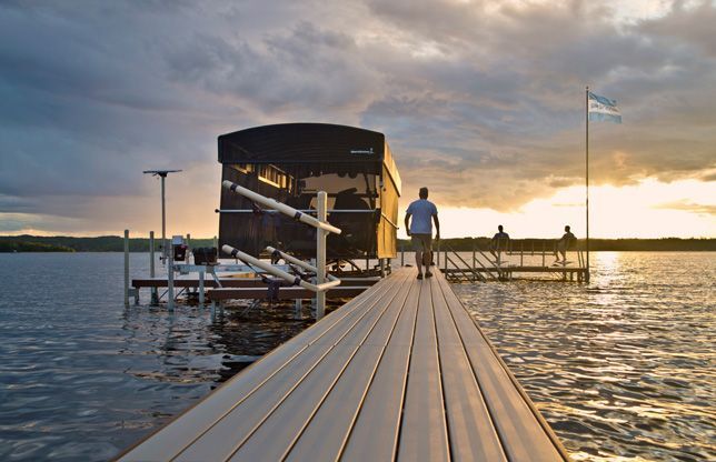 An image of a person walking a dock towards a canopy lift