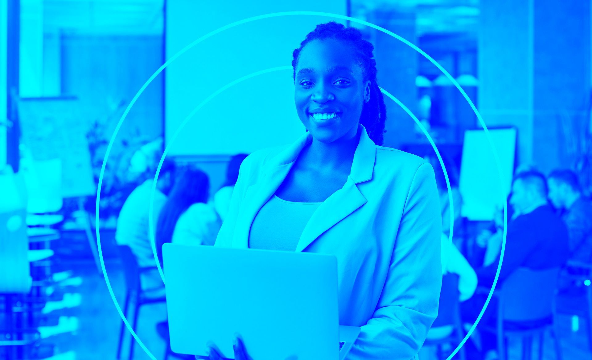 Smiling African woman standing in a boardroom holding a laptop