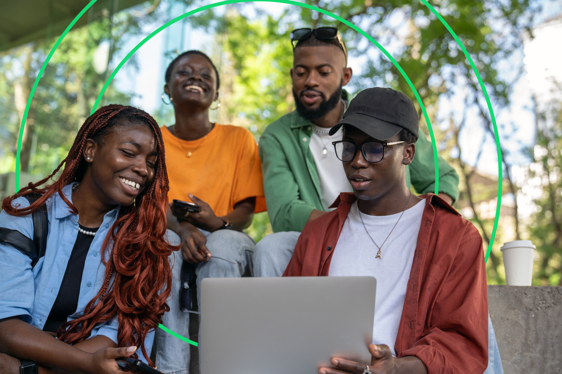 Group of smiling happy people looking at a laptop