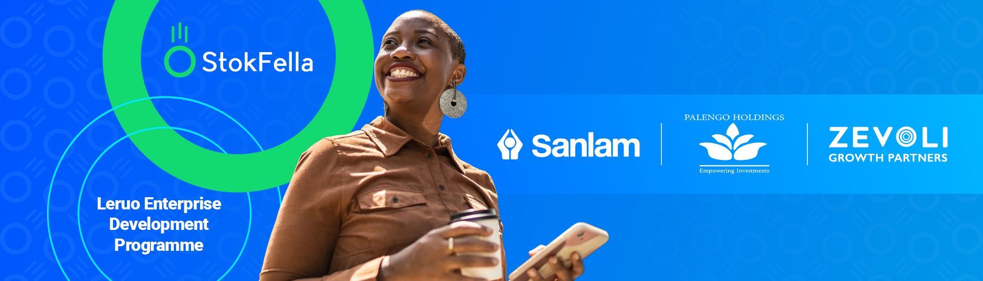 A woman is holding a book in front of a blue background.