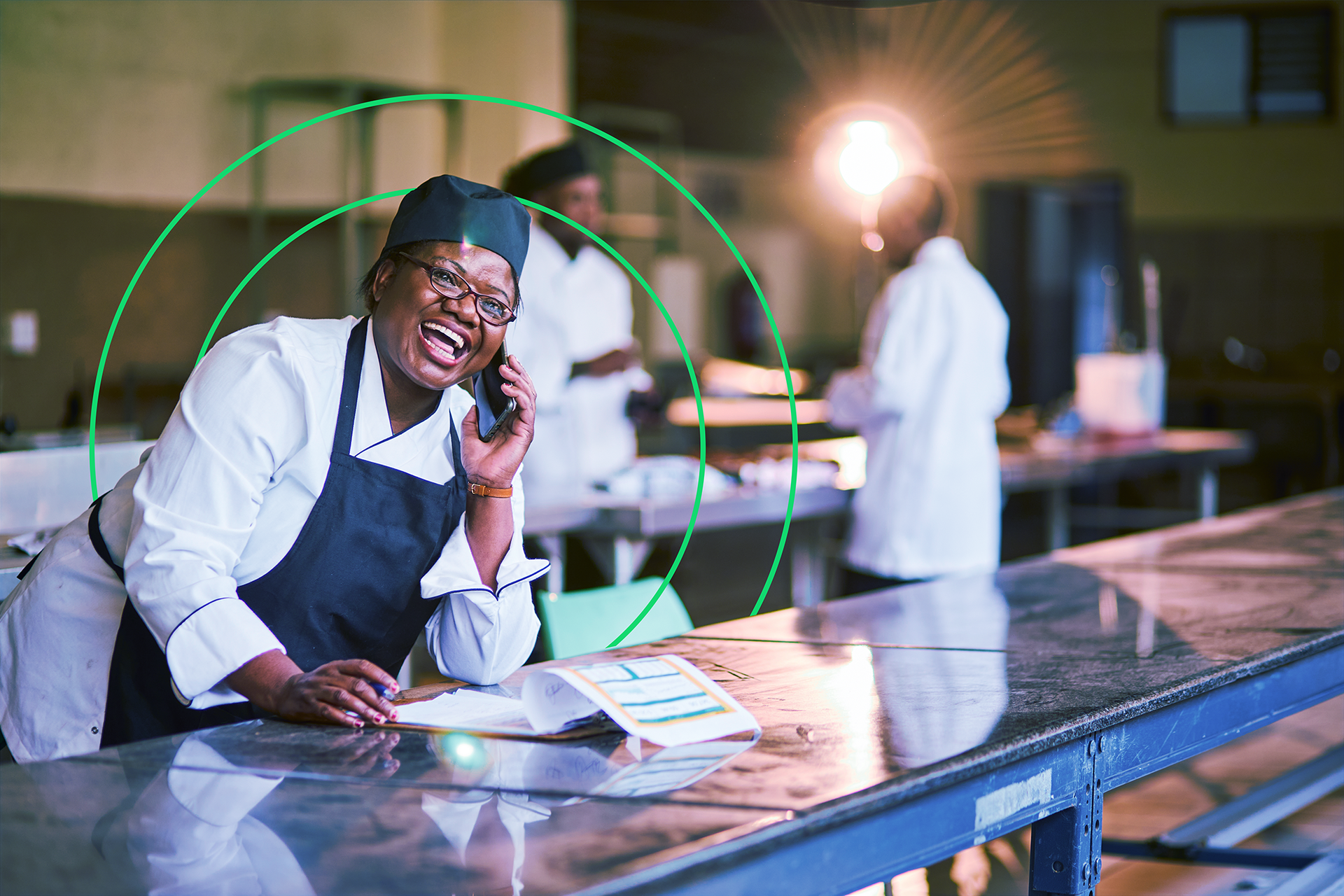 Happy woman in chefs outfit making notes on clipboard