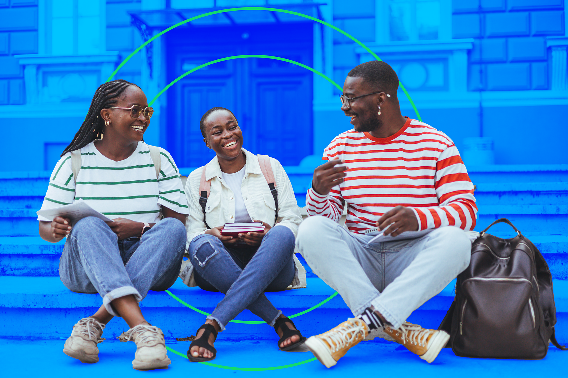 Group of happy students sitting on steps in front of building.