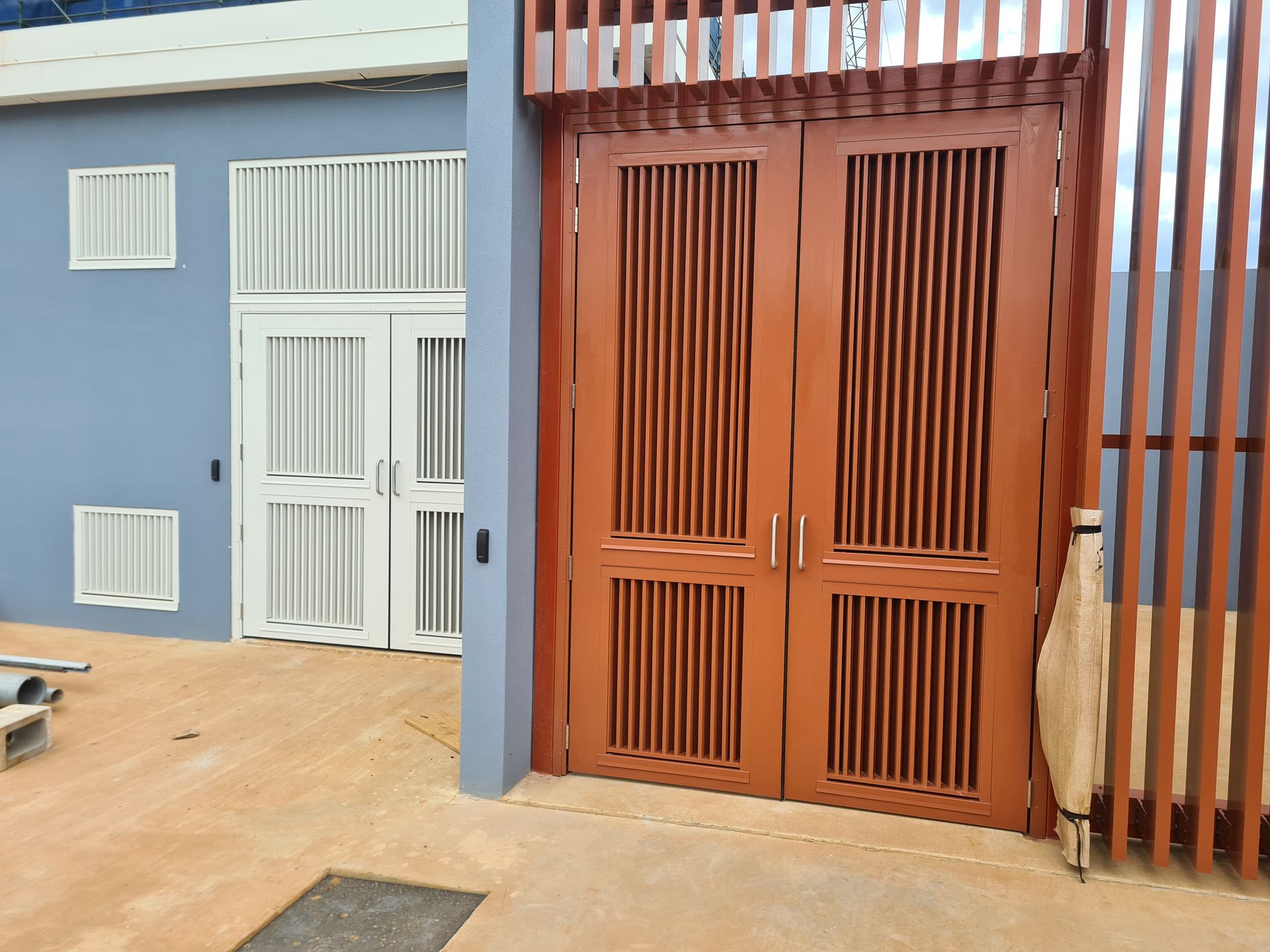 Brown Double Doors And Fence; White Door On Blue Building — Advancetech Glass & Glazing in Wulguru, QLD