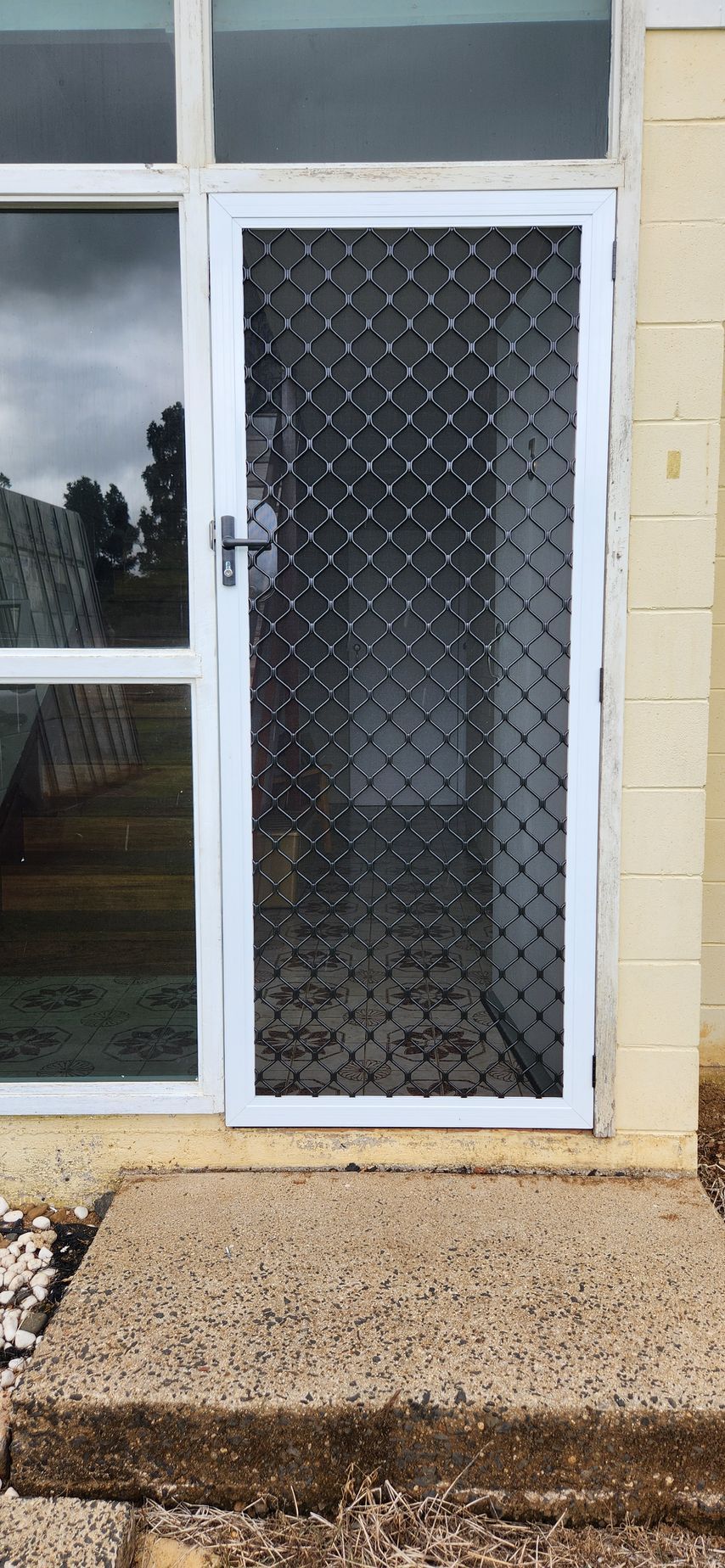 Modern bathroom with glass shower, window, heated towel rack, and sink 