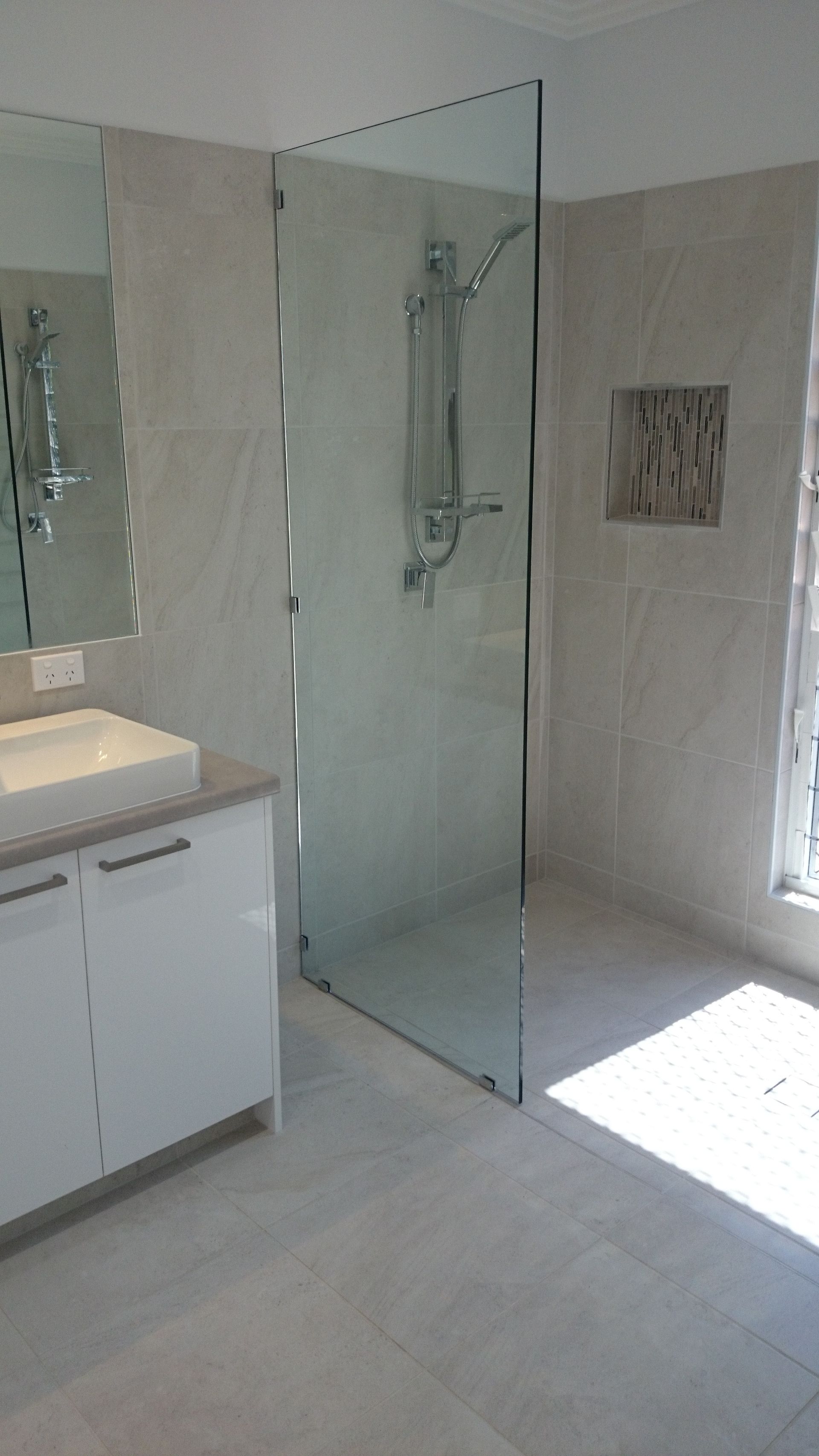 Bathroom with a frosted glass shower, white toilet and vanity, and overhead rain shower head — Advancetech Glass & Glazing in Wulguru, QLD 