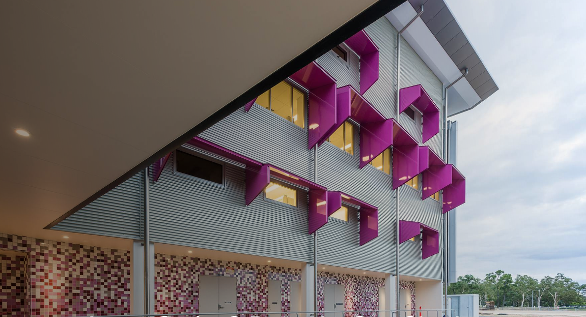 Modern Building With Pink Accents And Wavy Metal Facade, Angled Roof, And Mosaic-tiled Wall — Advancetech Glass & Glazing in Wulguru, QLD