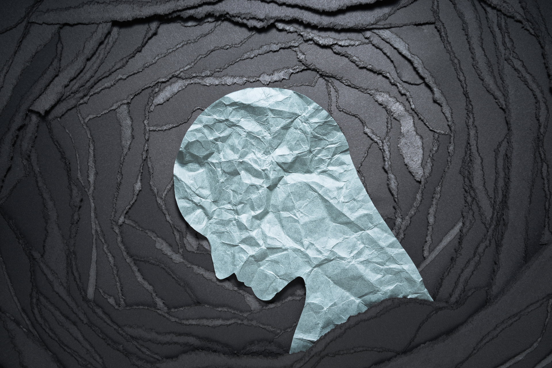 a drawing of a person 's head made out of crumpled paper .