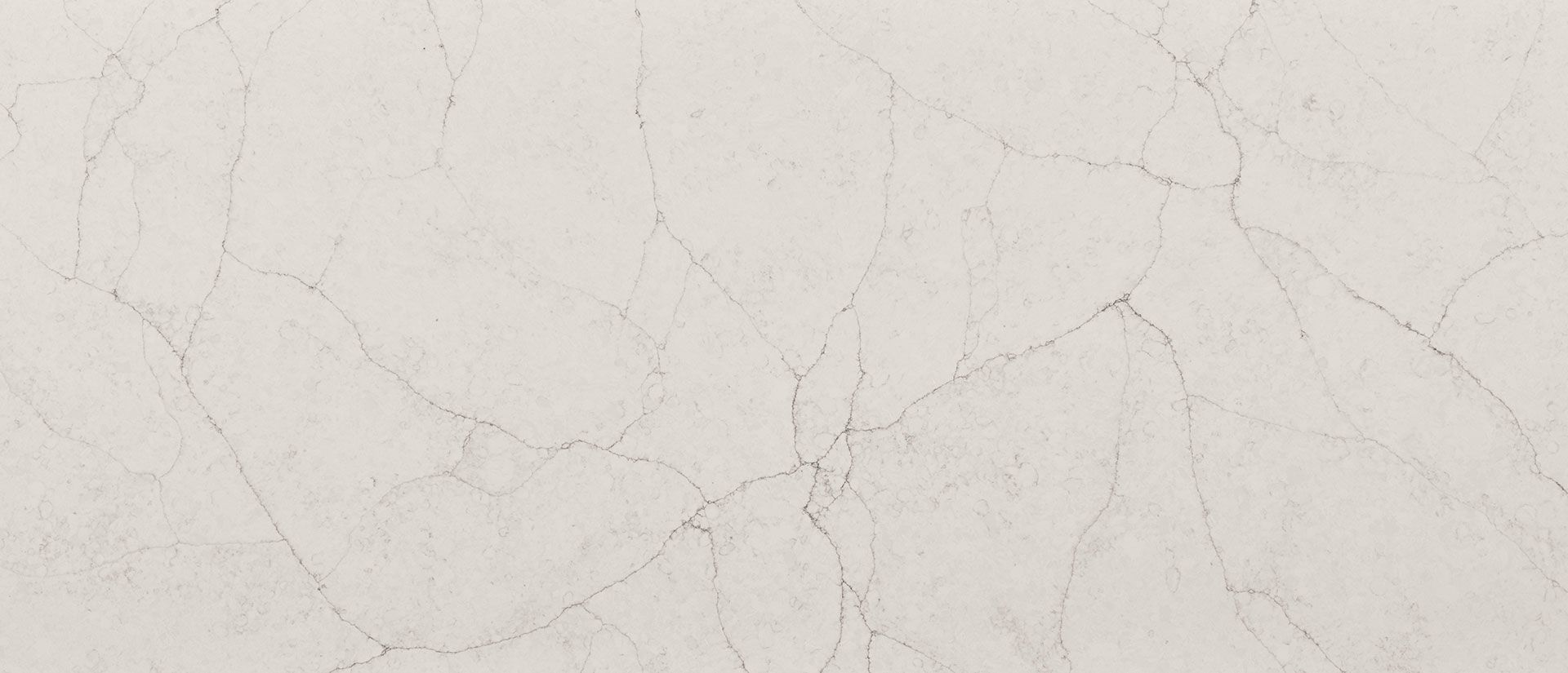Cream-colored surface with subtle gray veining, resembling marble or stone.
