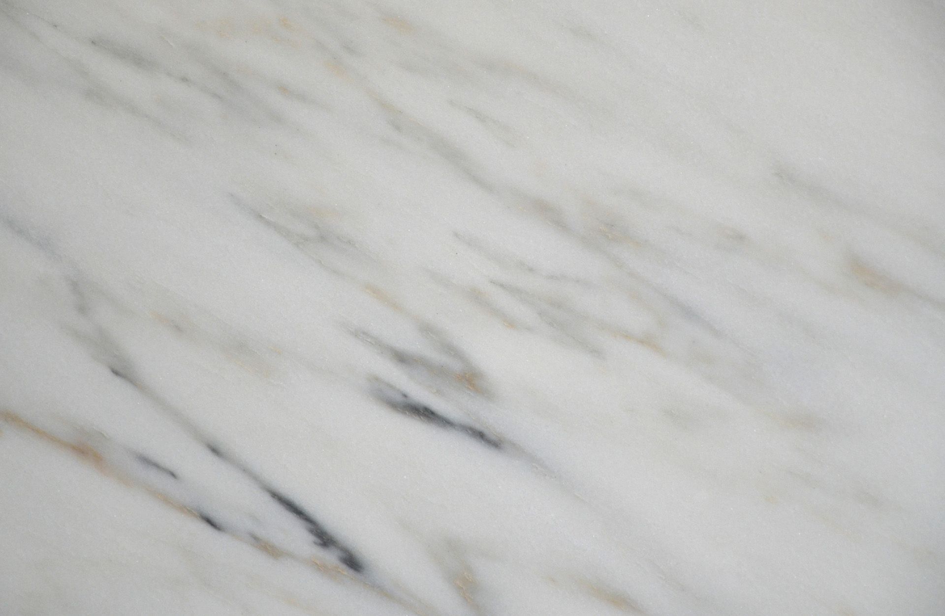 White marble with gray and brown veining.