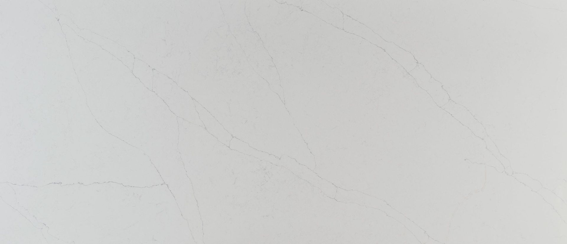 White, textured surface with faint, irregular veining patterns.