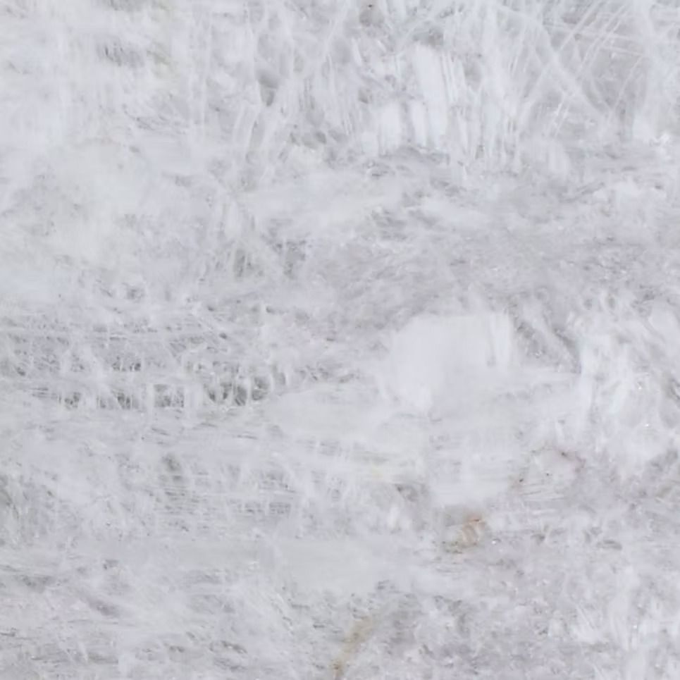 White and gray marble surface with intricate veining patterns.